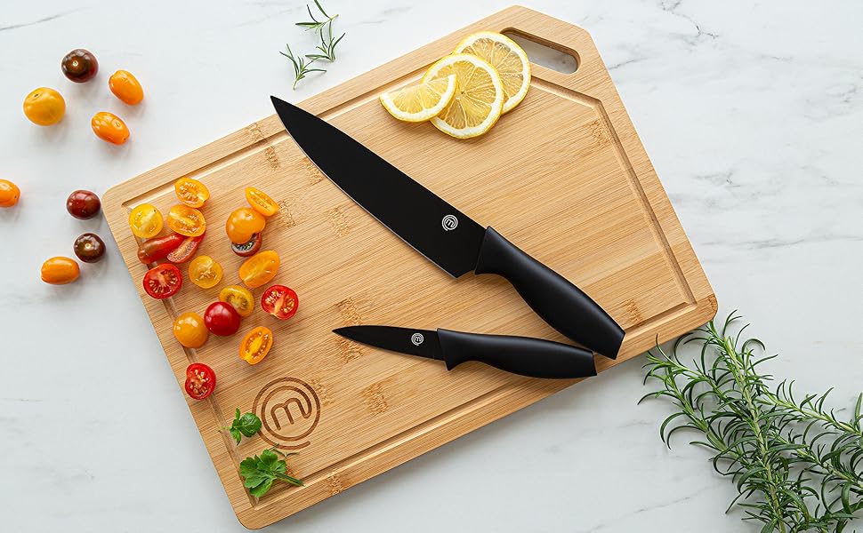 Knives cutting tomatoes on board